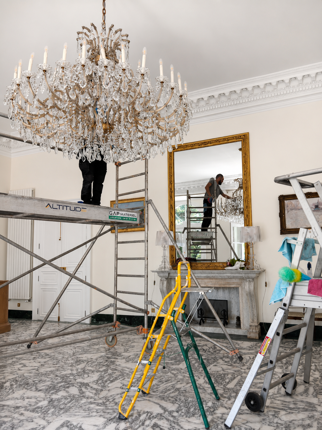 Technicien Clair'Net nettoyant un lustre en hauteur